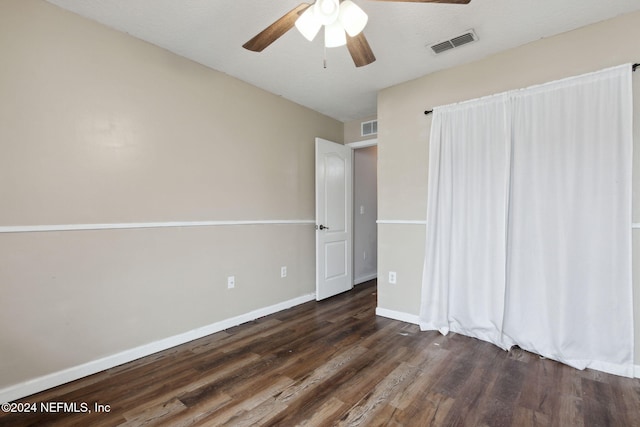 unfurnished bedroom with ceiling fan, dark hardwood / wood-style flooring, and a textured ceiling