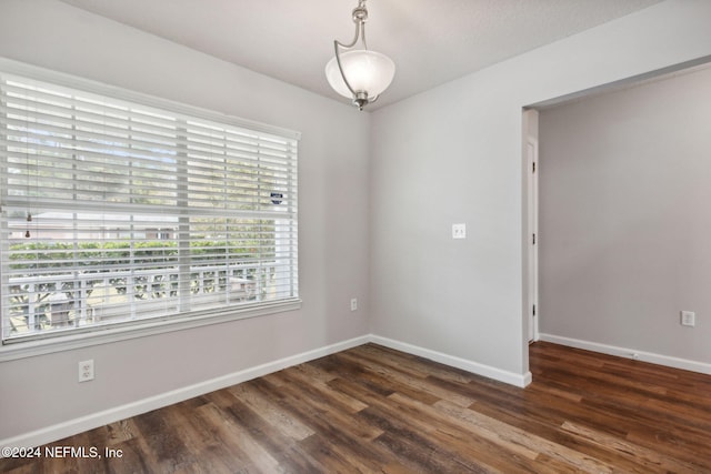 spare room with dark hardwood / wood-style flooring