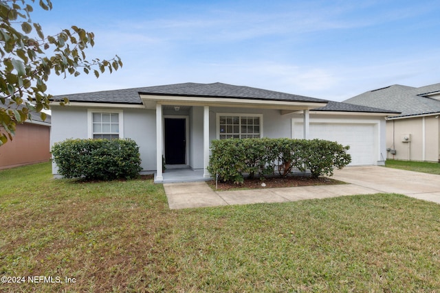 view of front of home with a front yard, a porch, and a garage