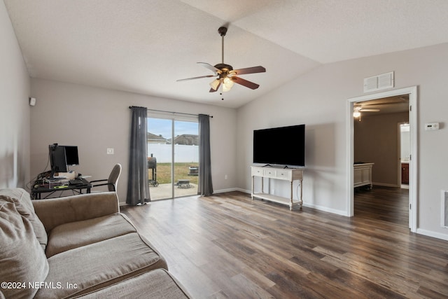 living room with ceiling fan, dark wood-type flooring, and vaulted ceiling