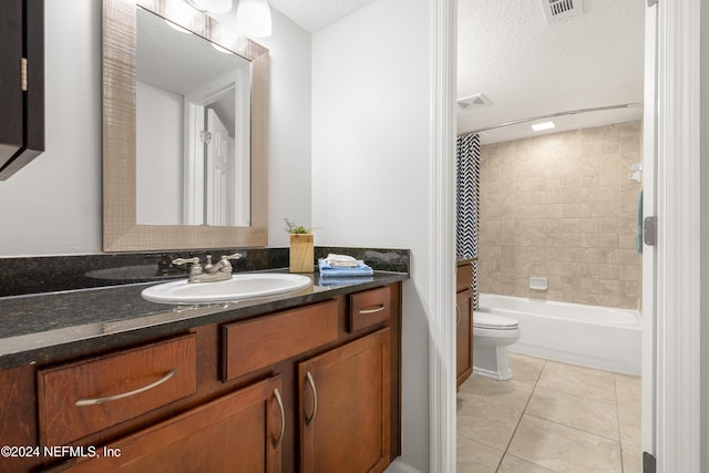 full bathroom with tile patterned flooring, visible vents, toilet, vanity, and a textured ceiling