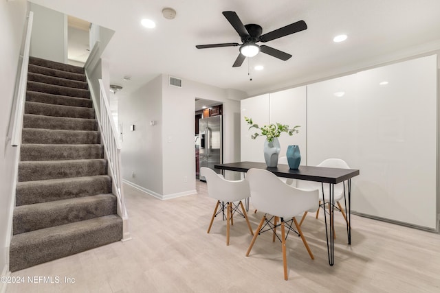 dining room with light wood-type flooring, visible vents, recessed lighting, and stairs