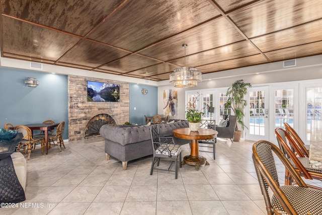 living room with visible vents, wooden ceiling, a fireplace, and french doors