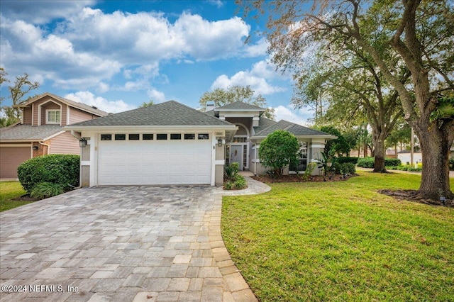 view of front of home featuring a garage and a front lawn