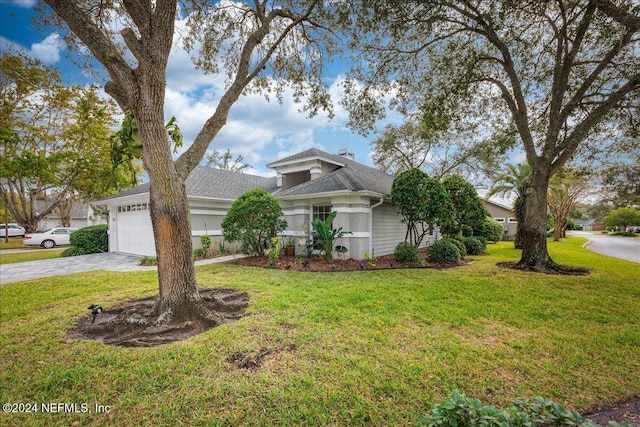 view of front of house featuring a front yard and a garage