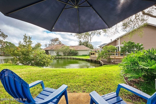 view of yard with a deck with water view