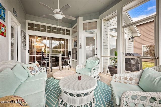 sunroom featuring ceiling fan