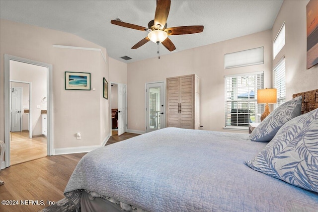 bedroom with a textured ceiling, wood finished floors, a ceiling fan, visible vents, and baseboards