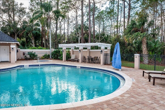 view of pool with a pergola and a patio area