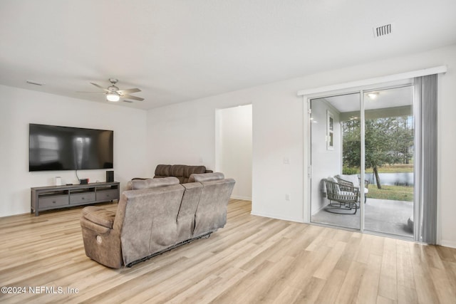 living room featuring ceiling fan and light hardwood / wood-style floors