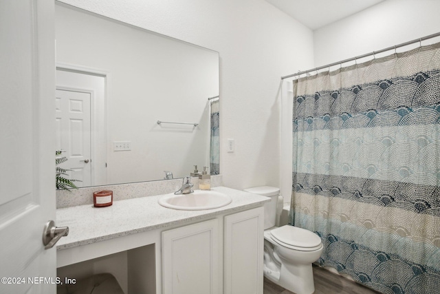 bathroom with hardwood / wood-style floors, vanity, and toilet