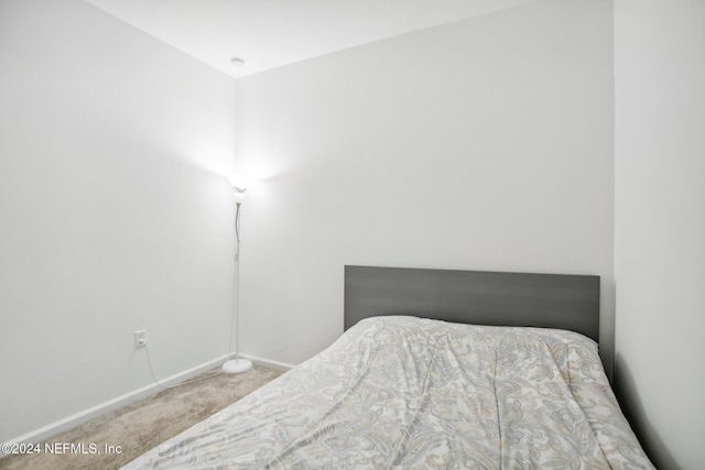 bedroom featuring carpet floors and lofted ceiling