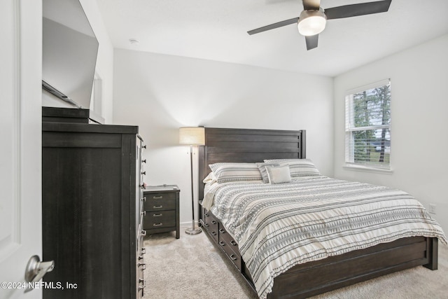 bedroom featuring ceiling fan and light carpet