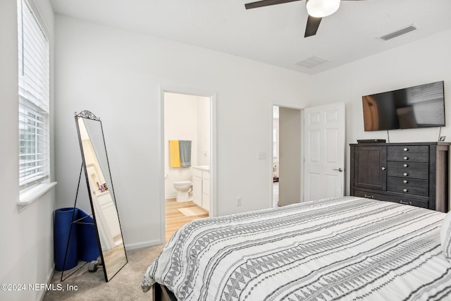 carpeted bedroom with connected bathroom and ceiling fan