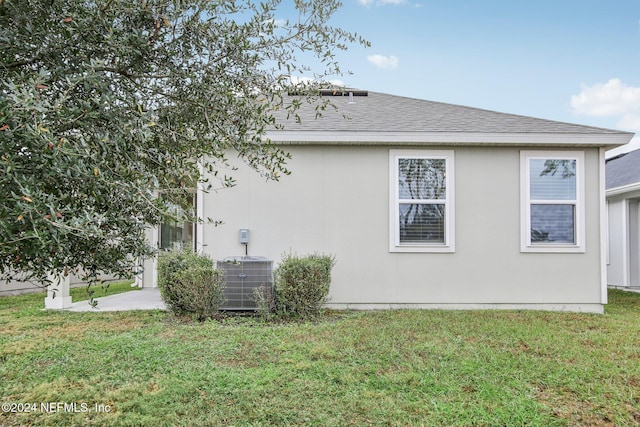 view of home's exterior with a yard and cooling unit