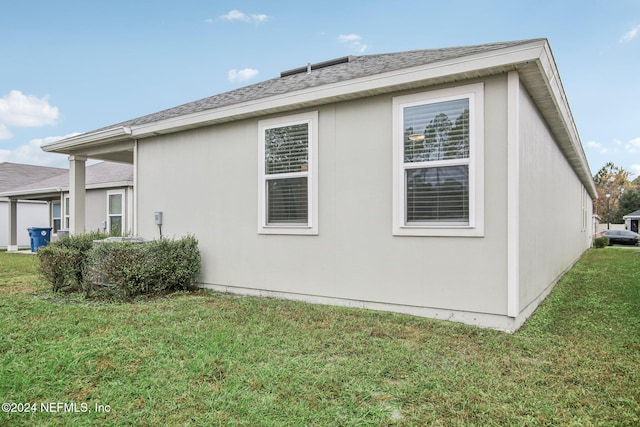 view of home's exterior with a lawn