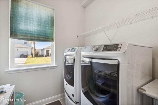 clothes washing area with washer and clothes dryer