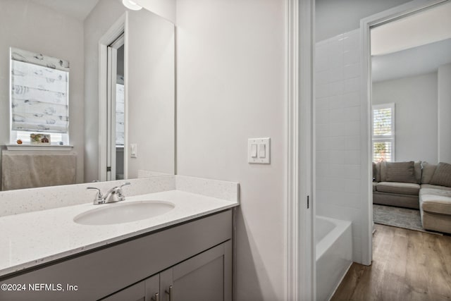 bathroom featuring shower / bathing tub combination, wood-type flooring, and vanity