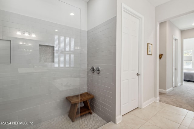 bathroom with tile patterned floors and a tile shower