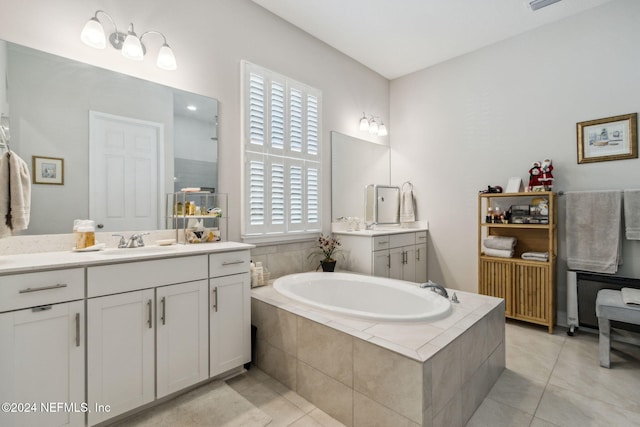 bathroom with tile patterned flooring, vanity, and a healthy amount of sunlight