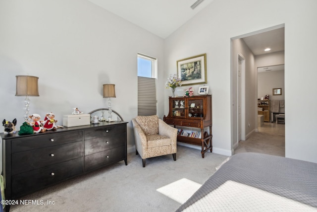 bedroom featuring light colored carpet and vaulted ceiling