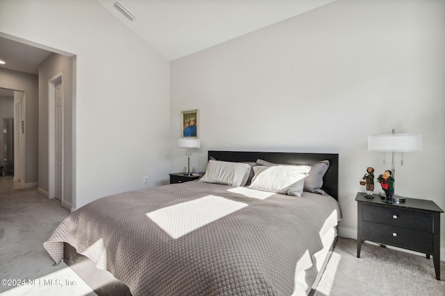 carpeted bedroom featuring lofted ceiling