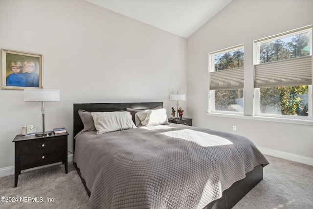 carpeted bedroom featuring high vaulted ceiling