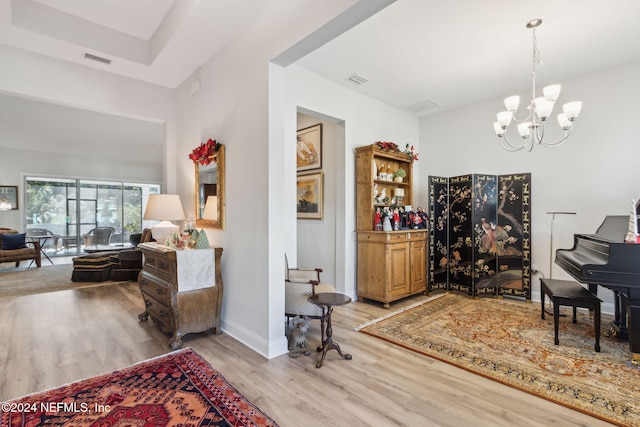 interior space with light hardwood / wood-style floors and an inviting chandelier