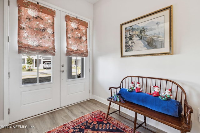 entryway featuring light wood-type flooring and french doors