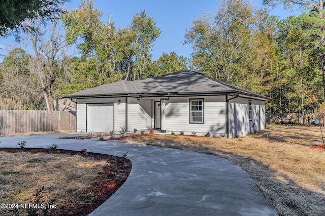 ranch-style home featuring a garage