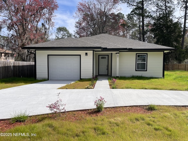 single story home featuring a garage, fence, concrete driveway, roof with shingles, and a front yard