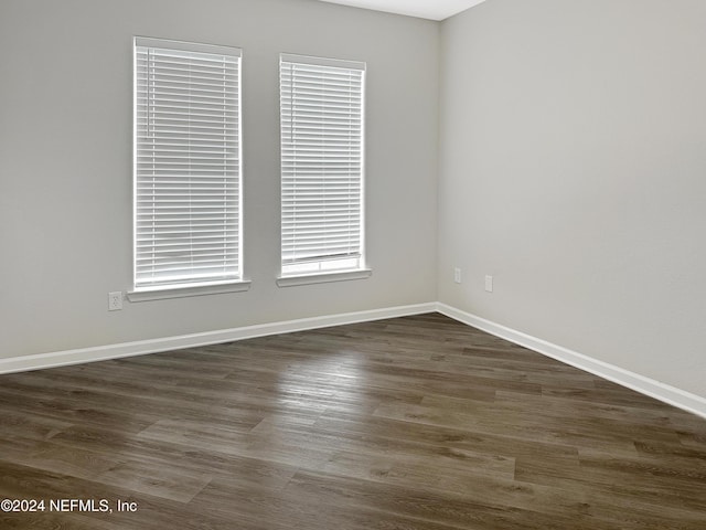 empty room with dark hardwood / wood-style flooring