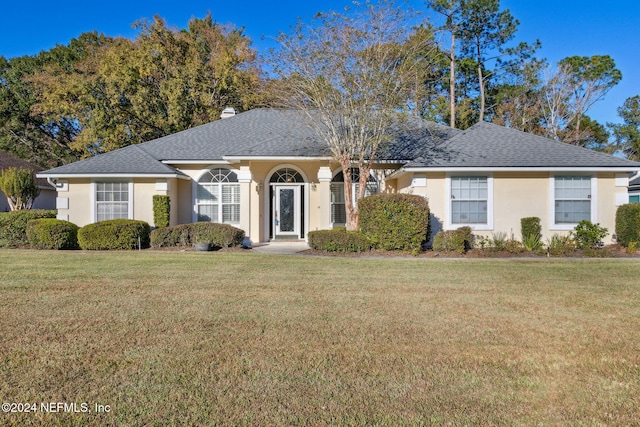 ranch-style home featuring a front yard