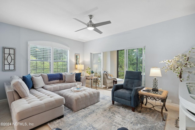 living room with light tile patterned flooring and ceiling fan