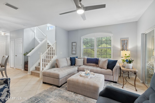 tiled living room featuring ceiling fan