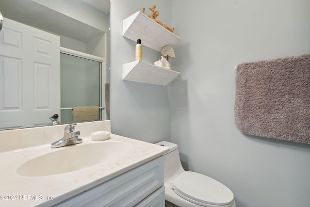 bathroom featuring walk in shower, vanity, and toilet