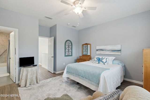 bedroom featuring hardwood / wood-style flooring, ensuite bath, and ceiling fan