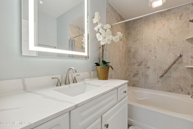 bathroom featuring vanity and tiled shower / bath