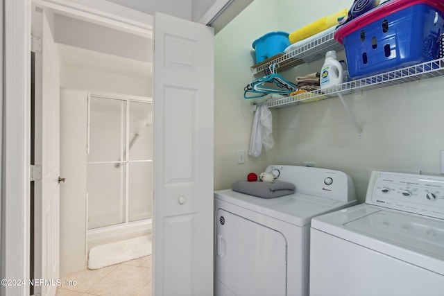 laundry room featuring washer and dryer and light tile patterned floors