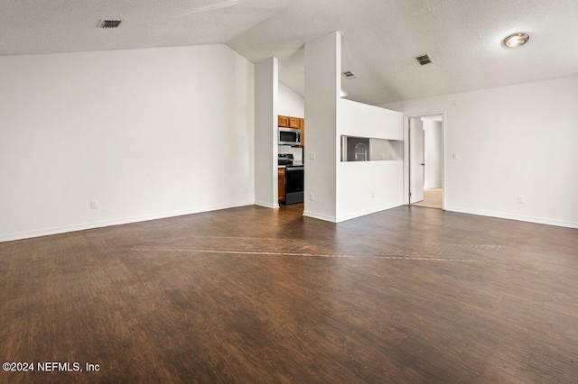 unfurnished living room with dark wood-type flooring, a textured ceiling, and vaulted ceiling