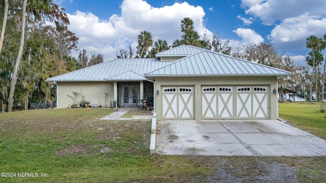 view of front of property with a front yard and a garage