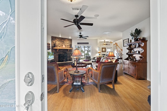 living room with light hardwood / wood-style floors and a fireplace