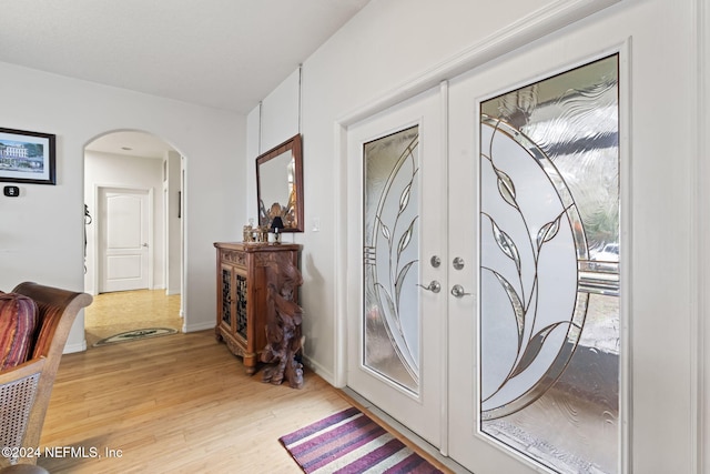 interior space featuring plenty of natural light, light hardwood / wood-style flooring, and french doors