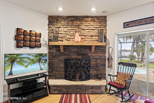 living room with hardwood / wood-style flooring and a fireplace