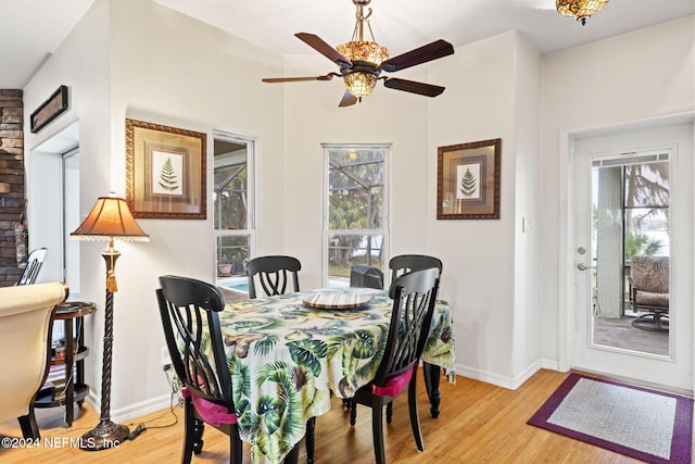 dining area with light hardwood / wood-style flooring and ceiling fan