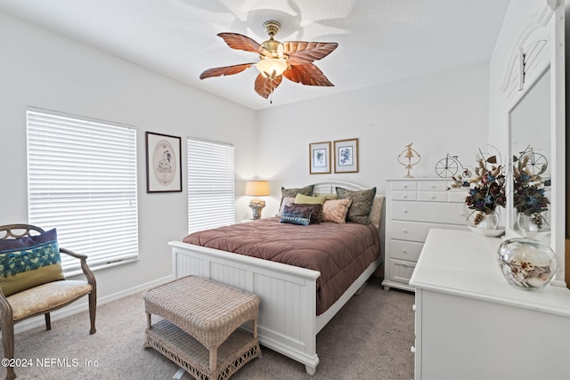 bedroom with light carpet and ceiling fan