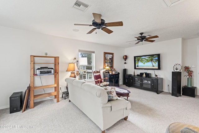 living room featuring ceiling fan and a textured ceiling