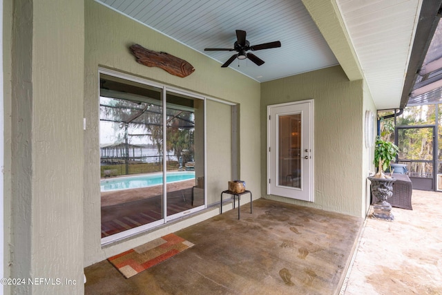 view of patio / terrace featuring glass enclosure and ceiling fan