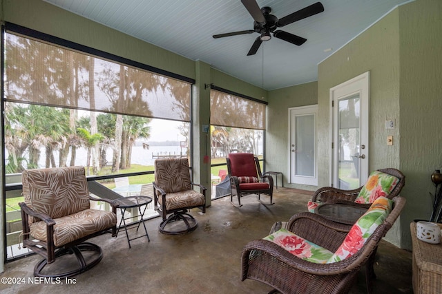 sunroom / solarium featuring ceiling fan