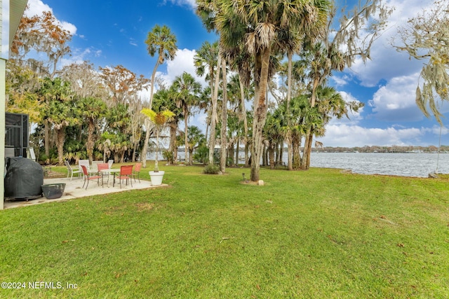 view of yard with a patio and a water view